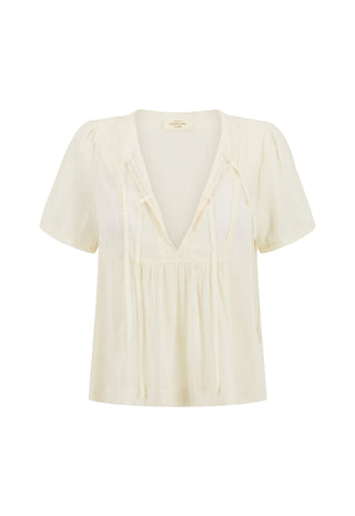 An off-white short-sleeve blouse with a deep V-neckline, tie details at the collar, and a gathered waist, shown against a plain white background.
