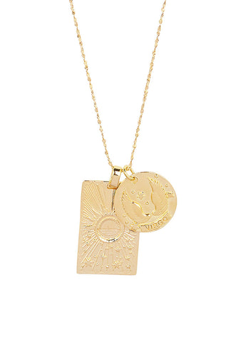 Close up front view of Spell’s Virgo Stargazer Zodiac Necklace charms. One charm is of a rectangular shape and features a sun with stars while the other charm is circular and features the Zodiac label and icon.